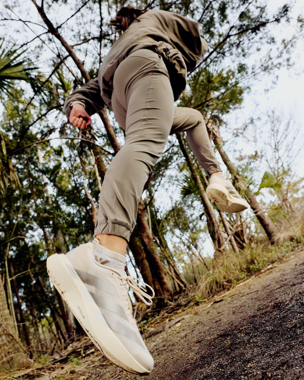 Runner wearing tan no-show socks and beige trail shoes