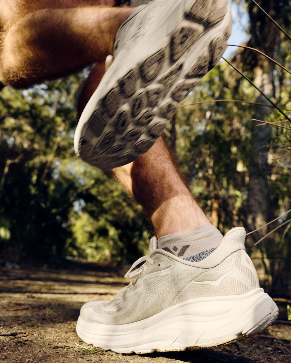 Runner wearing tan Flite XT No Show socks on a rocky trail