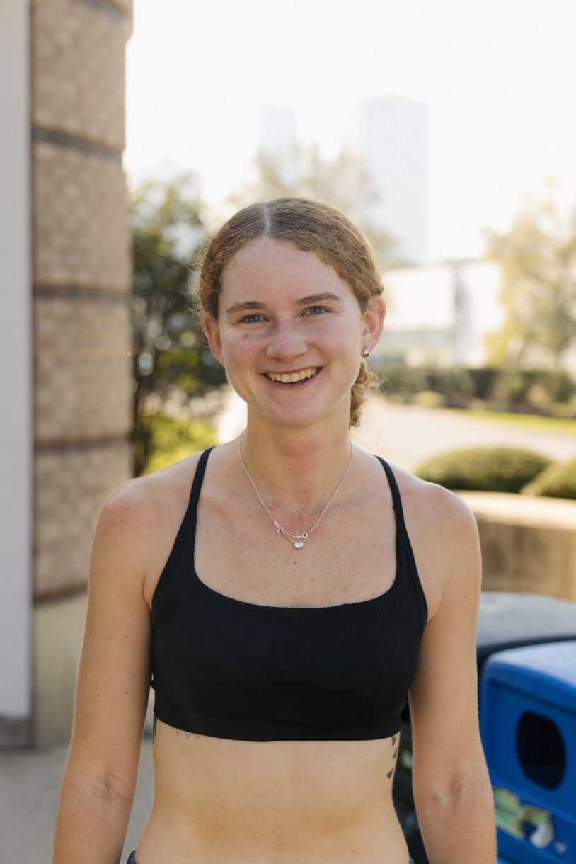 Smiling person outdoors wearing a black crop top