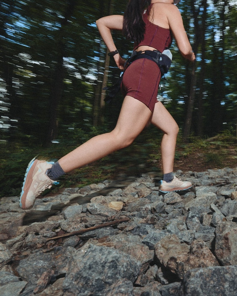 Trail runner wearing Flite XT Trail socks on rocky terrain