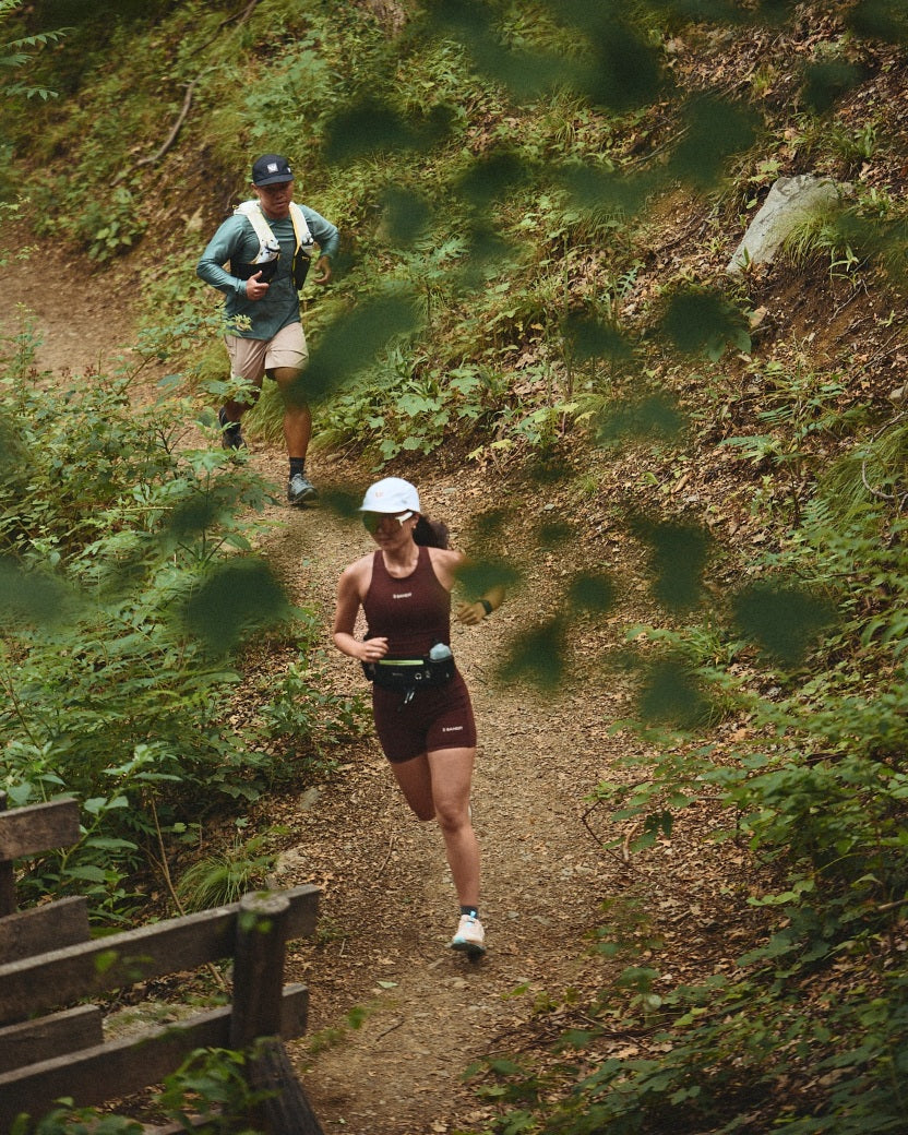 Two trail runners wearing Flite XT Trail socks in the woods