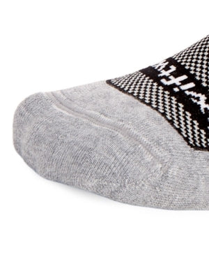 Close-up of a gray sock toe with Swiftwick branding and textured pattern.